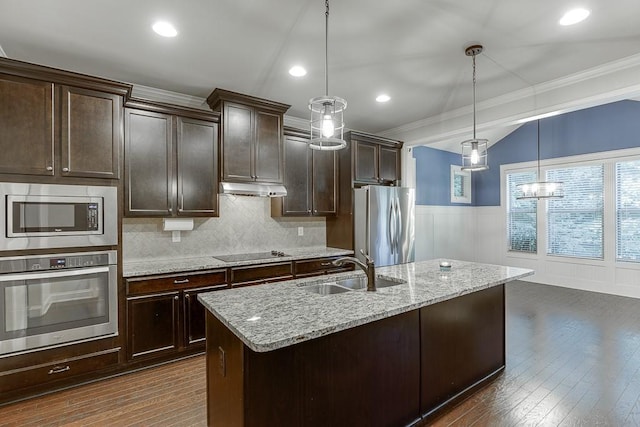 6206 Little Cove Dr, Flowery Branch, GA 30542 - kitchen with stainless steel appliances, ornamental molding, dark brown cabinets, light stone counters, and decorative light fixtures