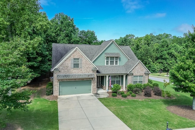 6206 Little Cove Dr, Flowery Branch, GA 30542 - craftsman house featuring brick siding, driveway, a front lawn, an attached garage, and a shingled roof