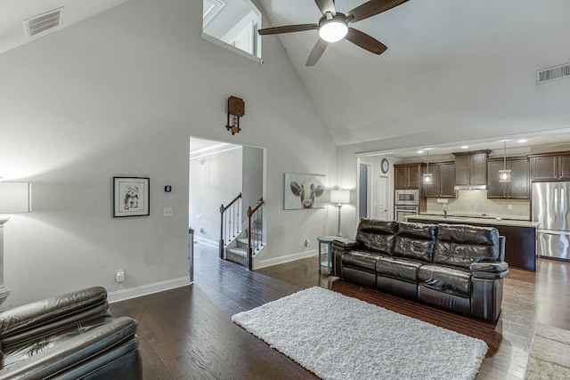6206 Little Cove Dr, Flowery Branch, GA 30542 - living room with high vaulted ceiling, ceiling fan, stairs, dark wood-style floors, and recessed lighting