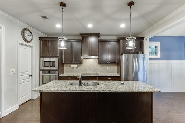 6206 Little Cove Dr, Flowery Branch, GA 30542 - kitchen with stainless steel appliances, ornamental molding, a kitchen island with sink, under cabinet range hood, and dark brown cabinetry