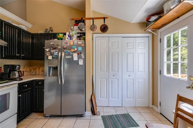 80 Jacob Trl, Rockmart, GA 30153 - kitchen with stainless steel fridge, electric range, dark cabinets, vaulted ceiling, and light countertops