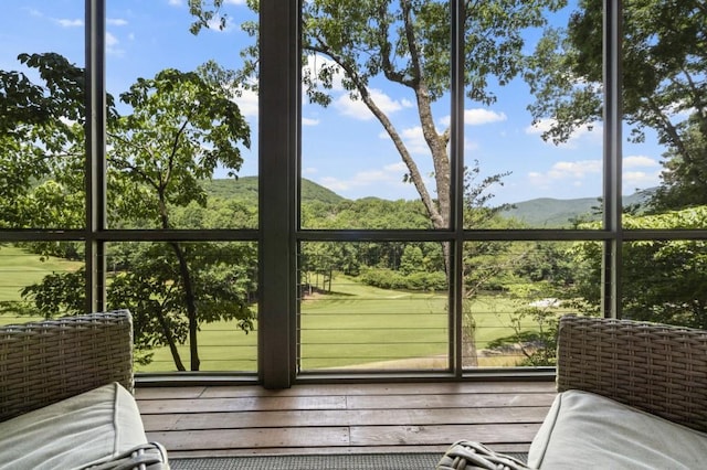 unfurnished sunroom with a mountain view