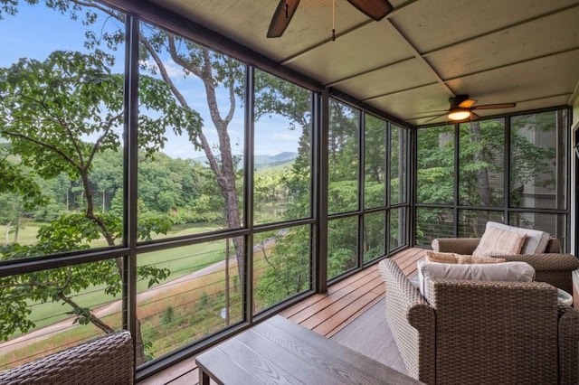 sunroom with a ceiling fan