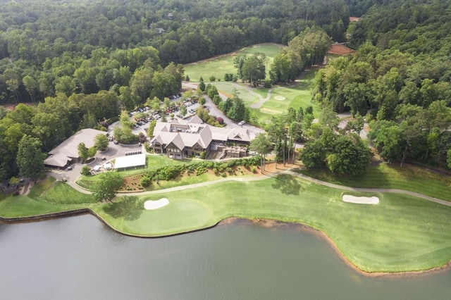 birds eye view of property with a water view and a wooded view