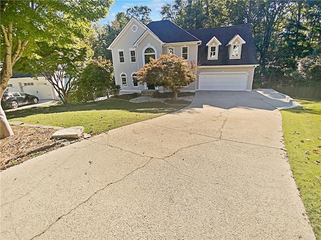 view of front of house with a garage and a front yard