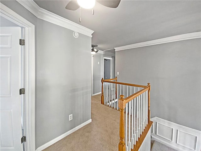 corridor featuring ornamental molding and light carpet