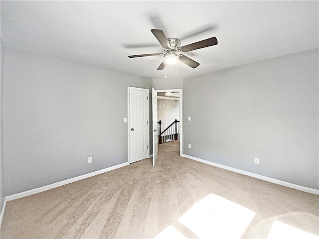 unfurnished bedroom featuring ceiling fan and carpet