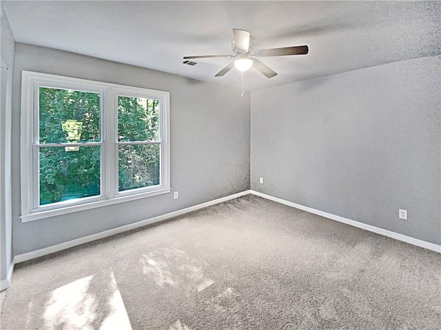 spare room featuring carpet floors and ceiling fan