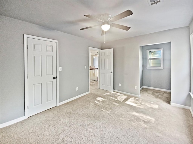 unfurnished bedroom featuring light carpet and ceiling fan