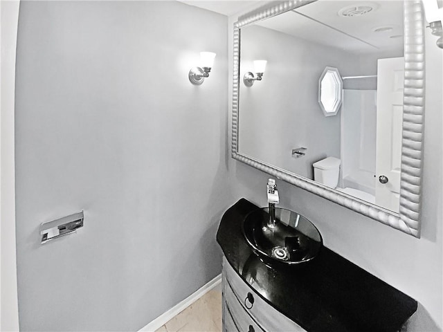 bathroom with tile patterned floors, vanity, and toilet