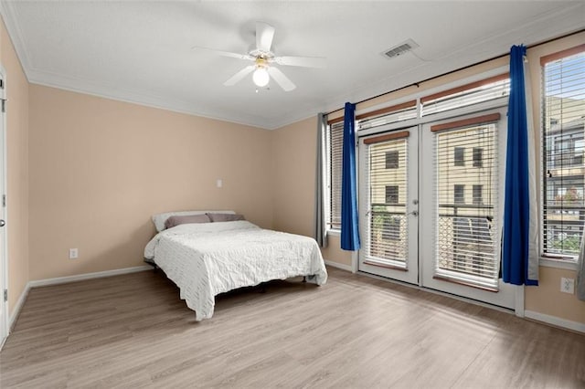 bedroom featuring access to outside, crown molding, baseboards, and wood finished floors