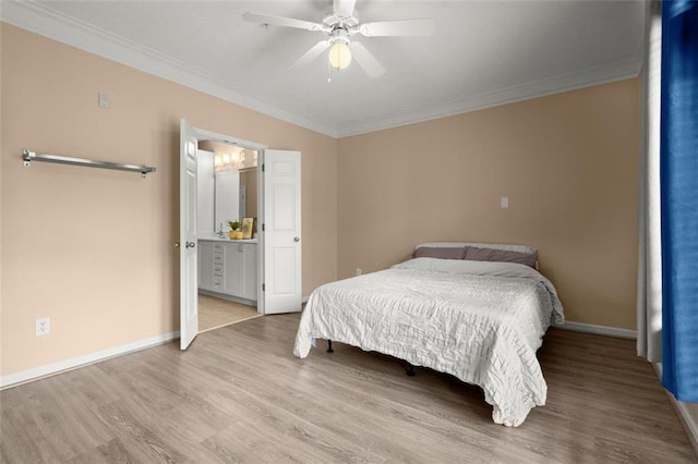 bedroom with crown molding, baseboards, and wood finished floors