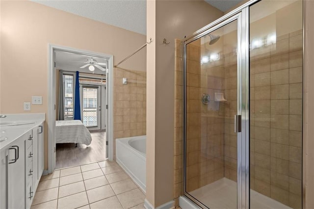 bathroom with tile patterned flooring, a garden tub, and a shower stall