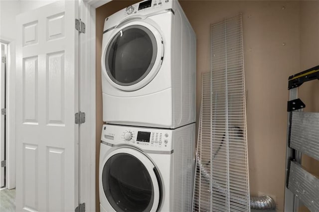 laundry area with laundry area and stacked washer and clothes dryer