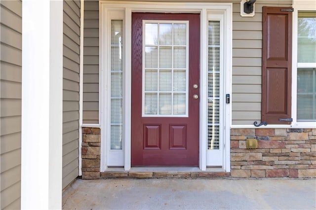 entrance to property featuring stone siding