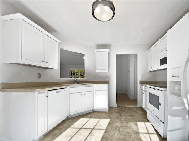 kitchen with white appliances, sink, and white cabinets