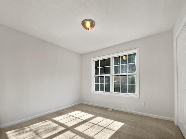 unfurnished room with light carpet