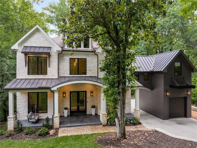 306 Pinecrest Rd NE, Atlanta, GA 30342 - modern inspired farmhouse featuring a standing seam roof, french doors, covered porch, an attached garage, and metal roof