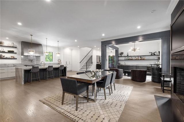 306 Pinecrest Rd NE, Atlanta, GA 30342 - dining space featuring stairs, light wood-style flooring, recessed lighting, a fireplace, and ornamental molding
