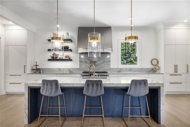 306 Pinecrest Rd NE, Atlanta, GA 30342 - kitchen with modern cabinets, decorative backsplash, white cabinets, light wood finished floors, and a spacious island