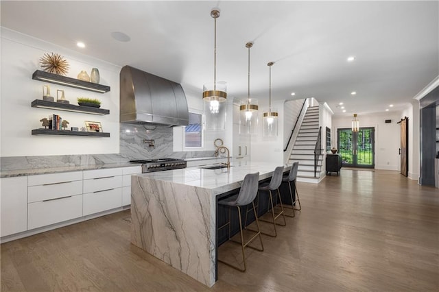306 Pinecrest Rd NE, Atlanta, GA 30342 - kitchen featuring wall chimney exhaust hood, modern cabinets, a sink, high end range, and tasteful backsplash