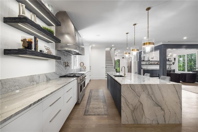 306 Pinecrest Rd NE, Atlanta, GA 30342 - kitchen with modern cabinets, high end stainless steel range, island range hood, a sink, and wood finished floors