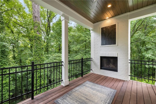 306 Pinecrest Rd NE, Atlanta, GA 30342 - wooden deck with a fireplace and a wooded view