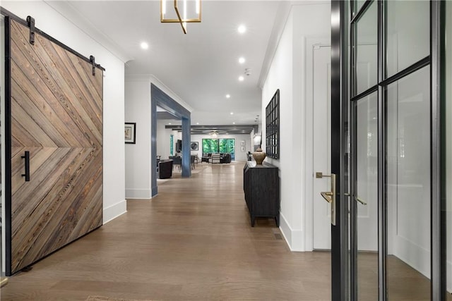 306 Pinecrest Rd NE, Atlanta, GA 30342 - hallway with a barn door, baseboards, wood finished floors, recessed lighting, and ornamental molding