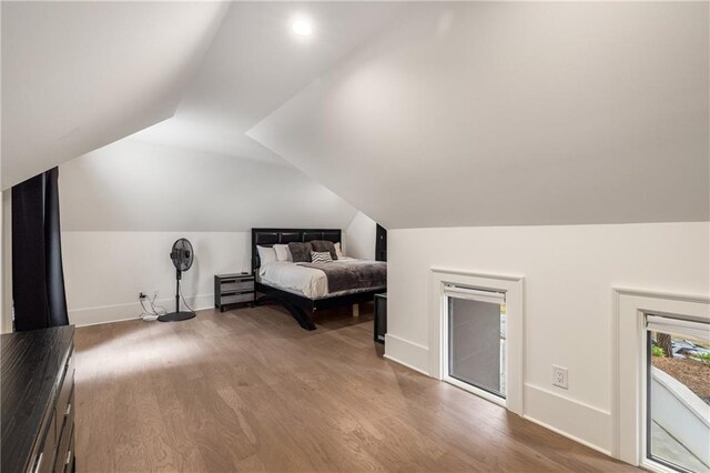 306 Pinecrest Rd NE, Atlanta, GA 30342 - bedroom featuring lofted ceiling, wood finished floors, baseboards, and access to exterior