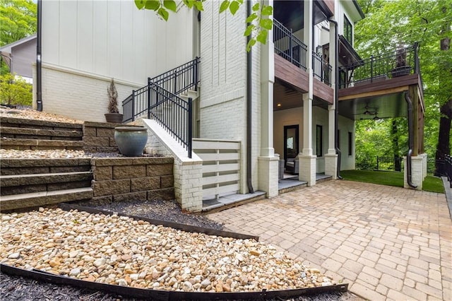 306 Pinecrest Rd NE, Atlanta, GA 30342 - view of side of home featuring stairway, brick siding, and a patio area