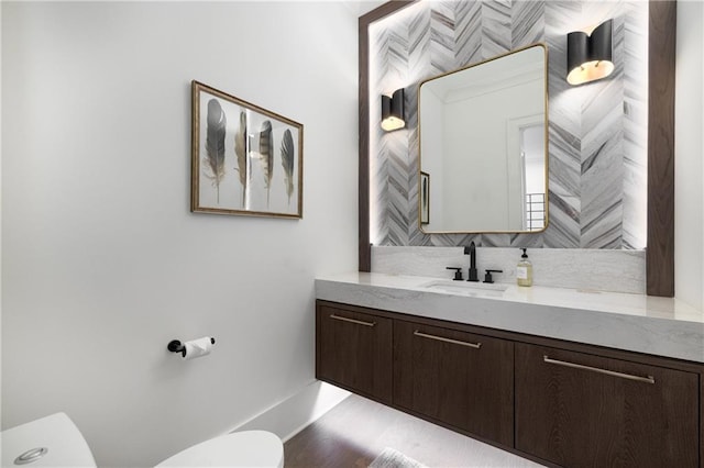 306 Pinecrest Rd NE, Atlanta, GA 30342 - half bath with toilet, baseboards, vanity, and backsplash