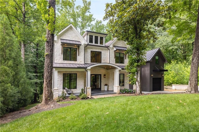 306 Pinecrest Rd NE, Atlanta, GA 30342 - view of front of house featuring a standing seam roof, a front yard, metal roof, and a garage