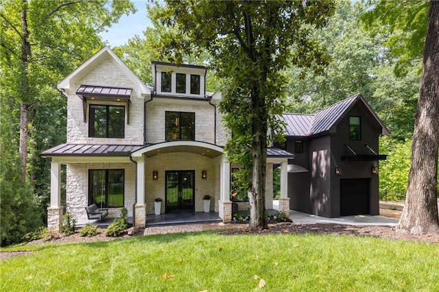 306 Pinecrest Rd NE, Atlanta, GA 30342 - view of front facade featuring a standing seam roof, french doors, a front lawn, and an attached garage