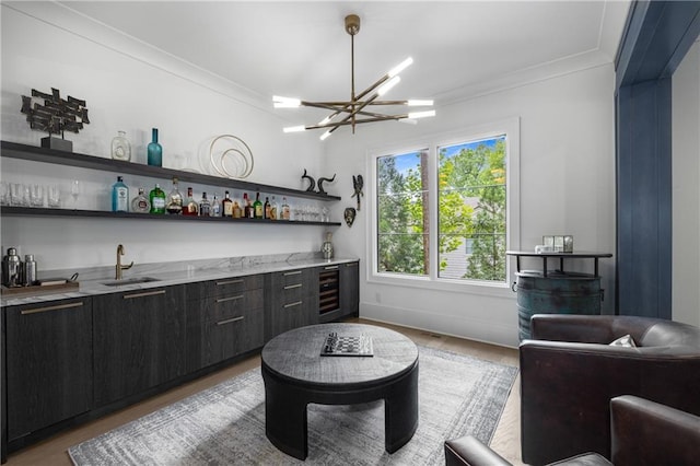 306 Pinecrest Rd NE, Atlanta, GA 30342 - indoor wet bar featuring ornamental molding, wood finished floors, a chandelier, and baseboards