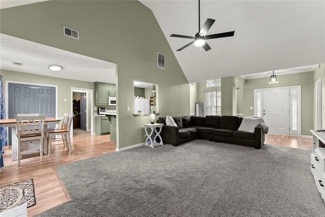 3625 Wapakonata Trl, Bethlehem, GA 30620 - living area featuring ceiling fan, high vaulted ceiling, light wood-type flooring, and baseboards
