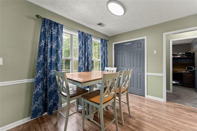 3625 Wapakonata Trl, Bethlehem, GA 30620 - dining space with light wood-type flooring, baseboards, and a textured ceiling