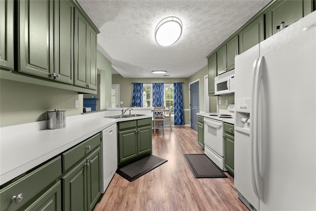 3625 Wapakonata Trl, Bethlehem, GA 30620 - kitchen featuring green cabinetry, white appliances, a sink, light wood finished floors, and light countertops