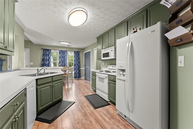 3625 Wapakonata Trl, Bethlehem, GA 30620 - kitchen with green cabinets, white appliances, light wood-style floors, and a textured ceiling