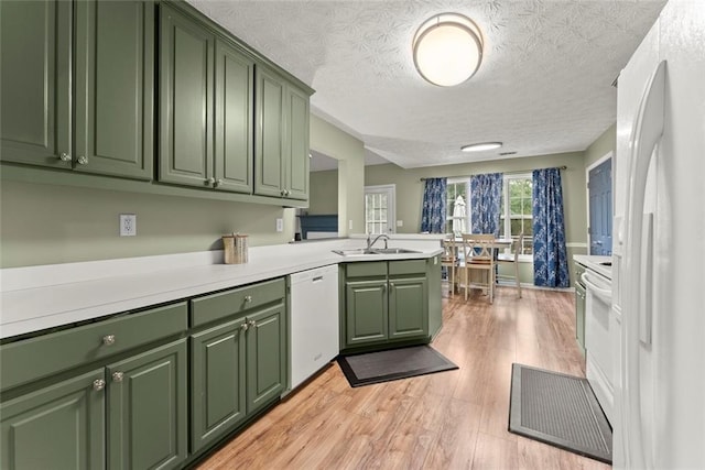 3625 Wapakonata Trl, Bethlehem, GA 30620 - kitchen featuring green cabinets, white appliances, a sink, light wood finished floors, and a textured ceiling