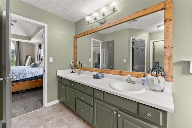 3625 Wapakonata Trl, Bethlehem, GA 30620 - ensuite bathroom with double vanity, a textured ceiling, baseboards, and tile patterned floors