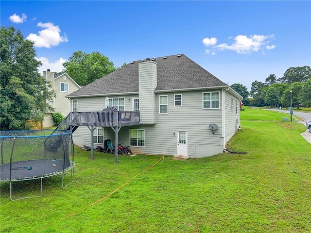 3625 Wapakonata Trl, Bethlehem, GA 30620 - back of property with a trampoline, a lawn, a deck, a chimney, and roof with shingles