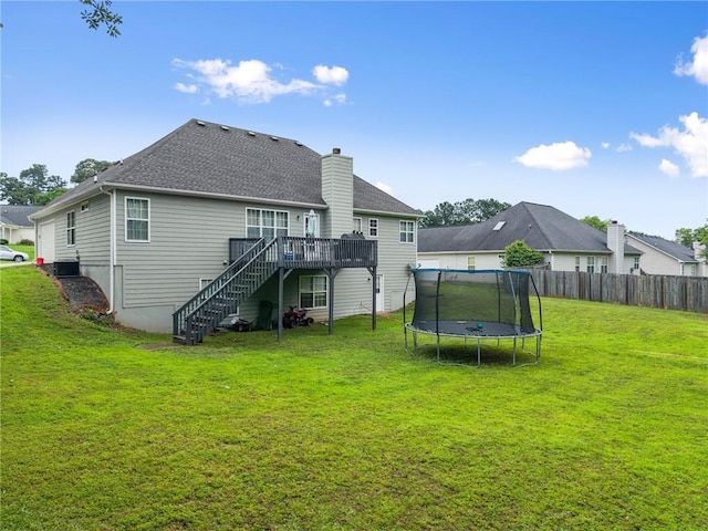 3625 Wapakonata Trl, Bethlehem, GA 30620 - back of house with a trampoline, stairway, a deck, a chimney, and a shingled roof