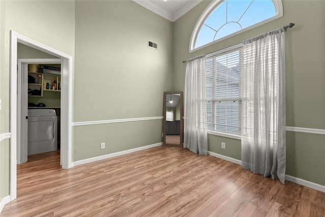 3625 Wapakonata Trl, Bethlehem, GA 30620 - unfurnished room with washer / clothes dryer, ornamental molding, light wood-style floors, baseboards, and a high ceiling