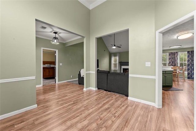 3625 Wapakonata Trl, Bethlehem, GA 30620 - unfurnished living room with a fireplace, light wood-style flooring, a ceiling fan, ornamental molding, and baseboards