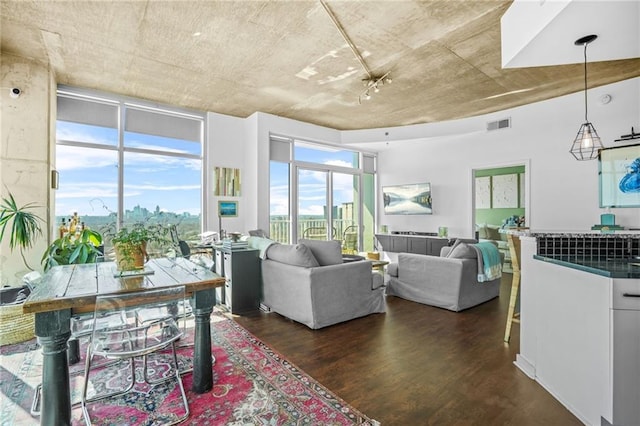 living area featuring a wall of windows, visible vents, and dark wood finished floors