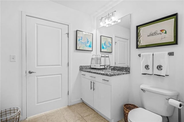 bathroom with tile patterned floors, toilet, and vanity