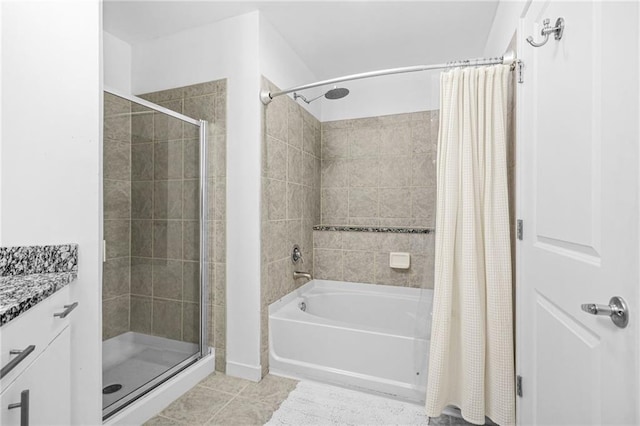 full bath with tile patterned floors, tiled shower / bath combo, and vanity