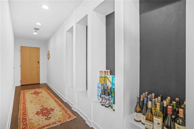 hallway with visible vents, recessed lighting, and baseboards