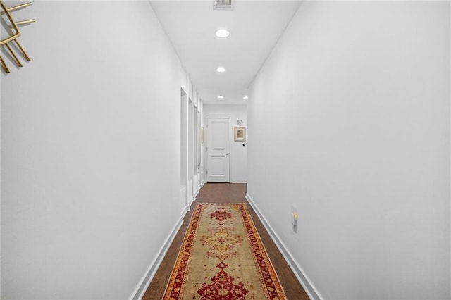 hallway with visible vents, recessed lighting, wood finished floors, and baseboards