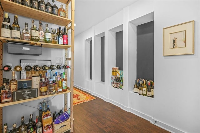 interior space featuring a bar and wood finished floors